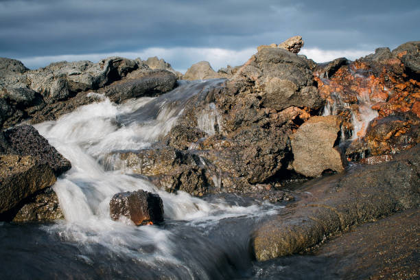 istock glacial water flowing through lava stones 1039730044
