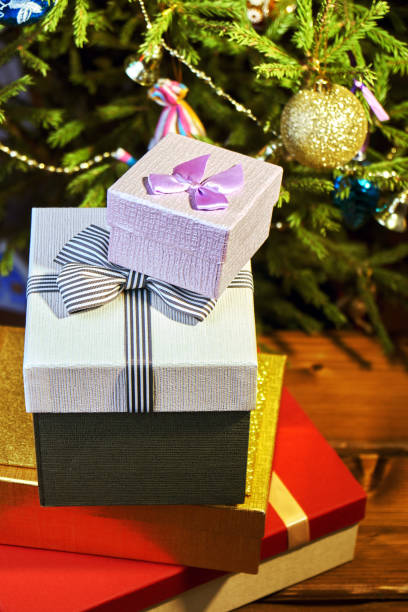 istock Gift boxes with bows on the lids under a Christmas tree in New Year Eve 1039732358