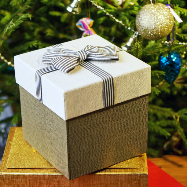 istock Gift boxes with bows on the lids under a Christmas tree in New Year Eve 1039732488