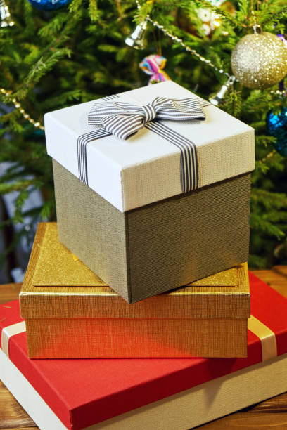 istock Gift boxes with bows on the lids under a Christmas tree in New Year Eve 1039732962