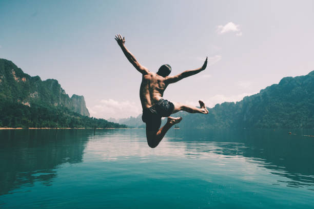 istock Man jumping with joy by a lake 1039740552