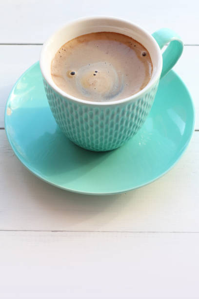 istock Coffee in a turquoise mug on a white wooden table 1039749704
