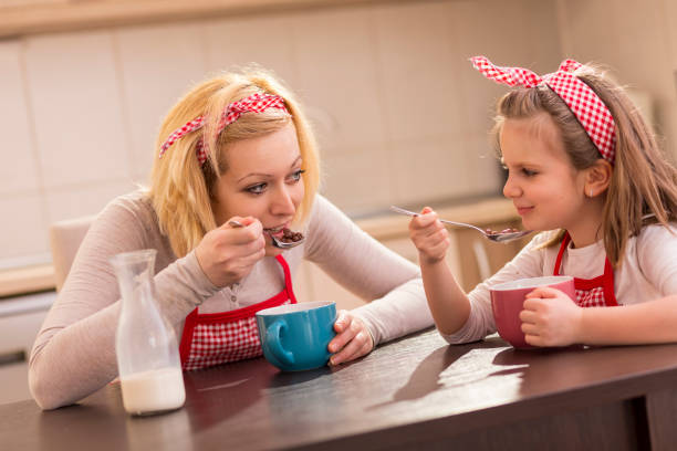 istock Mother and daughter eating cereal for breakfast 1039750706