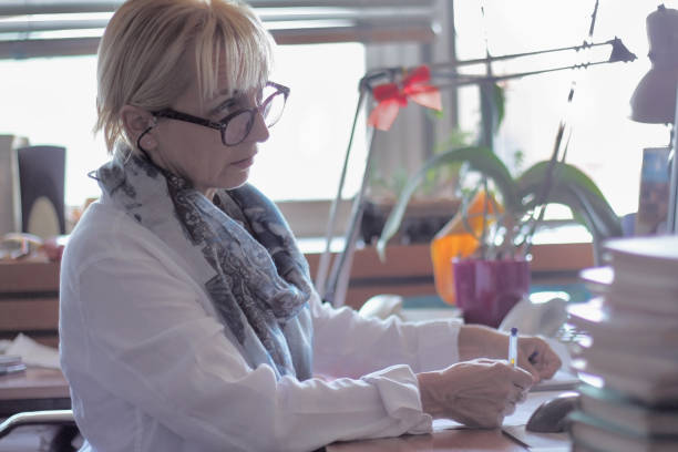 istock Mature woman Librarian among her books 1039753206