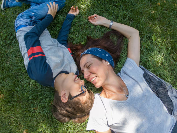 istock Happy mother and son lying on green grass 1039764672