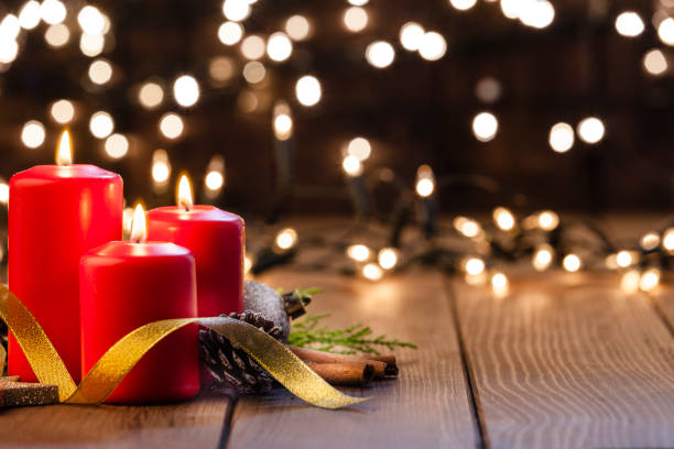 istock Christmas candles on rustic wooden table 1039765002