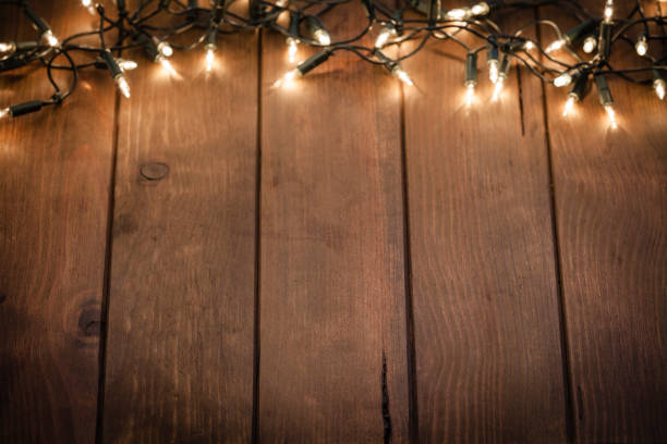 istock Empty rustic wooden table with blurred Christmas lights at background 1039765450