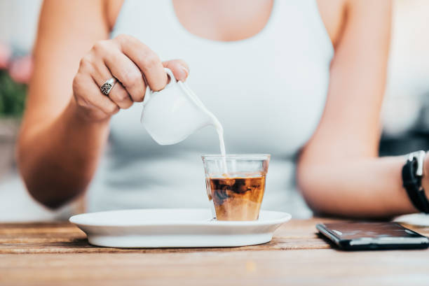 istock Pouring milik into coffee. Close-up. 1039766188