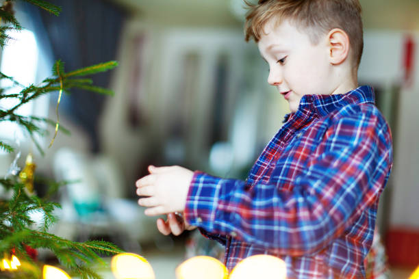 istock Little boy decorating Christmas tree 1039773358
