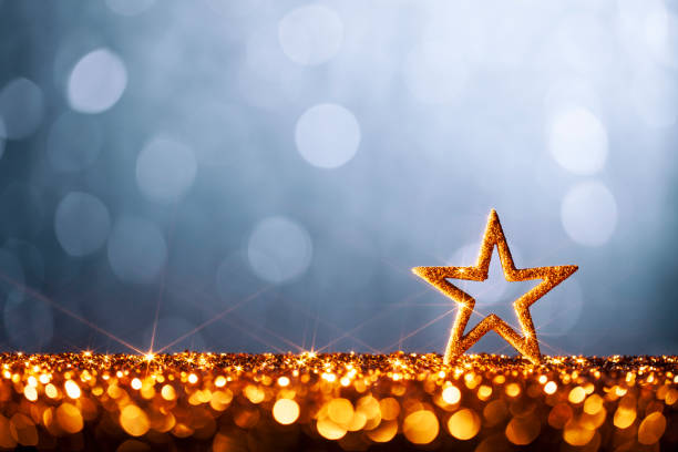 Decorative Christmas still life. Christmas star on gold and blue glitter background.