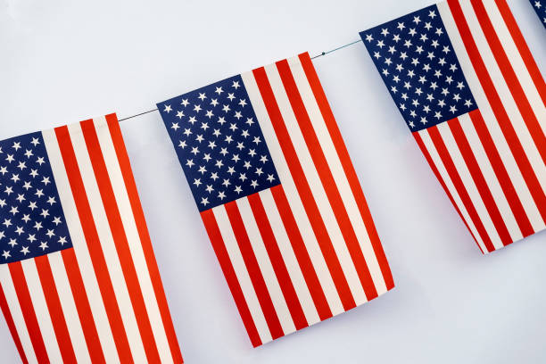 istock Garland of american flags of rectangular shape close-up on light background, banner design. Fest, city street holiday, celebration concept 1039801904