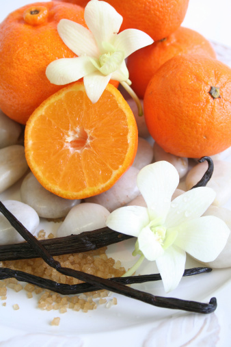 A colourful combo of sweet vanilla orchids and juicy mandarin. Narrow DOF. Focus is on flower.