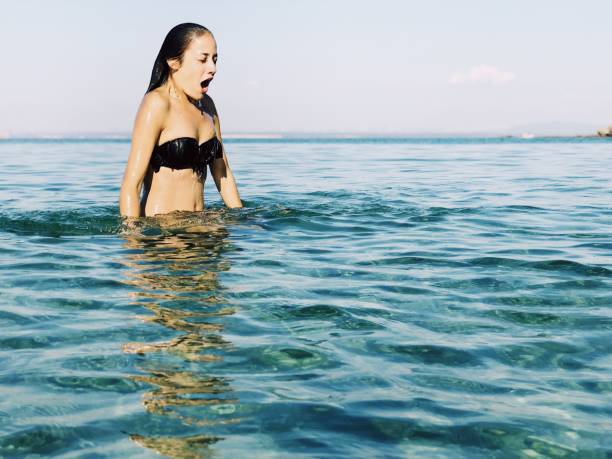 istock Young blond woman enjoying sea 1039811704