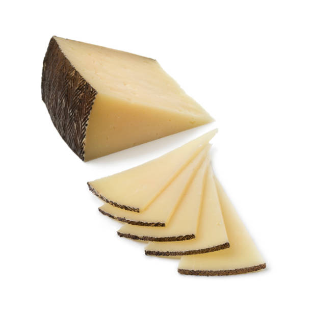 Slices of Spanish Manchego cheese Slices of traditional Spanish Manchego cheese isolated on white background machego stock pictures, royalty-free photos & images