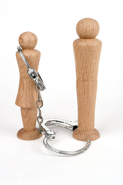 istock Man And Woman Figures With Handcuffs 103982153