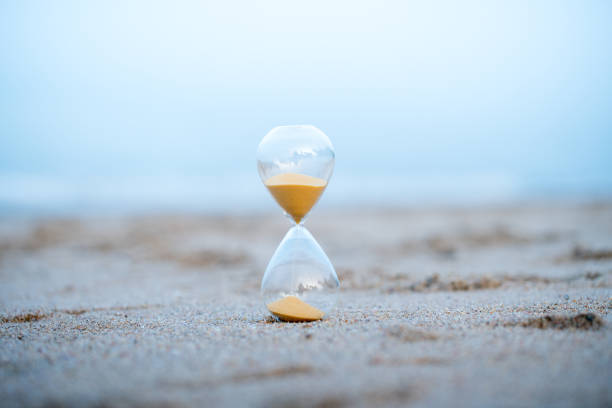 istock Sand clock on the beach, business time management concept 1039822138
