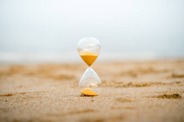 istock Sand clock on the beach, business time management concept 1039822324