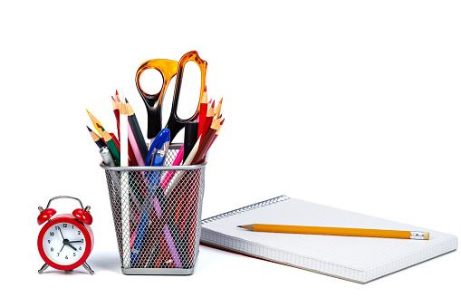 Close up of school and office supplies on white background.