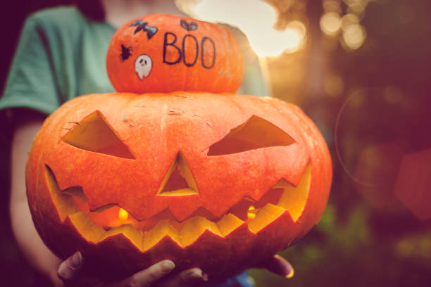 istock Women holding Halloween pumpkins 1039833376