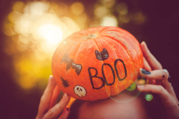 a woman with an eco-bag holds a ripe pumpkin in her hands