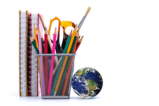 Close up of school and office supplies on white background.\n(Earth from Nasa: https://visibleearth.nasa.gov/view.php?id=5438)