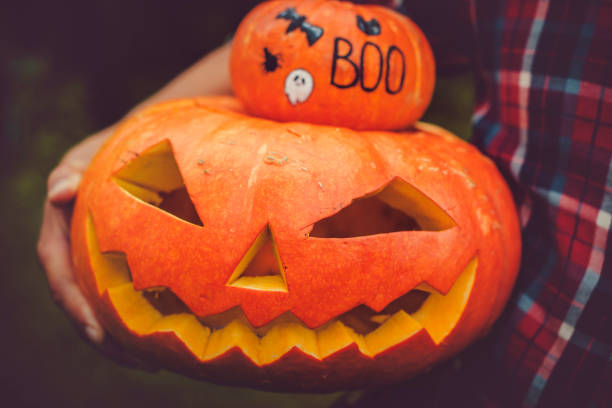 istock Man holding Halloween jack o' lantern  pumpkin 1039840802