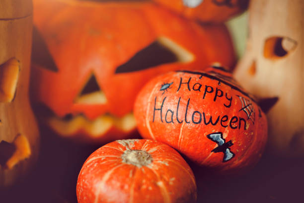 Halloween pumpkin with burning candles on black background.