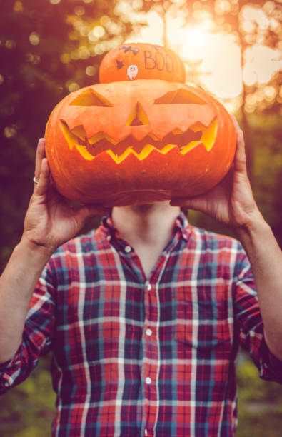 istock Man holding Halloween jack o' lantern  pumpkin 1039841090