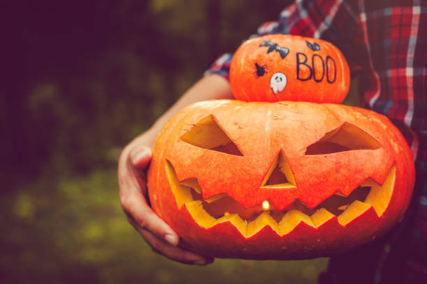 istock Man holding Halloween jack o' lantern  pumpkin 1039841266