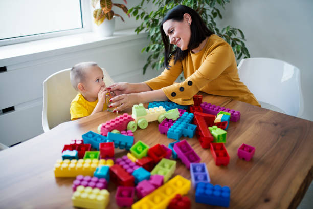 istock Mother and son having fun at home, playing with cubes 1039846014