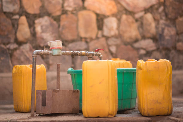 bidons et seaux à côté d’un robinet pour recueillir l’eau à nyamirambo, une partie semi-rurale de kigali (rwanda) - borehole photos et images de collection