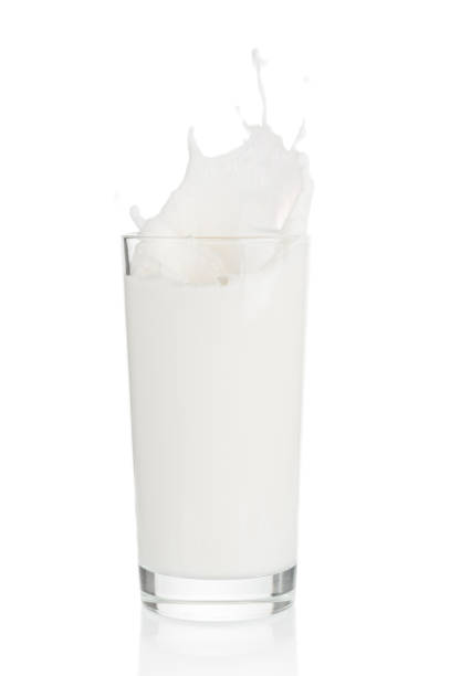 istock Splash of milk from glass on white background 1039846438