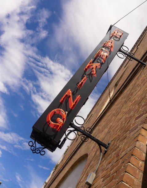 Neon Parking Sign on Black Background Mounted on Brick