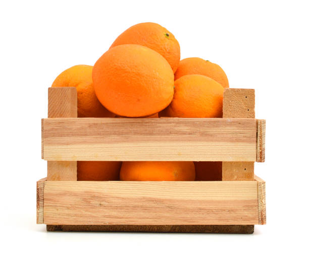 istock fresh oranges in a wooden box on a white background 1039875186