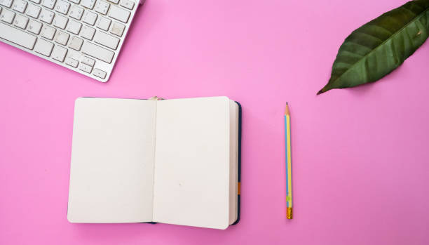 istock Tropical leaves with keyboard and note book on pastel pink background. minimal concept. Flat lay. 1039875204