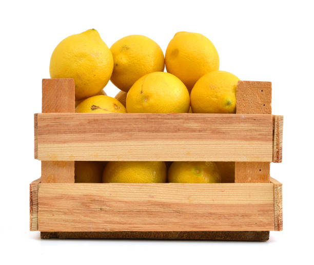 istock fresh lemons in a wooden box on a white background 1039876080