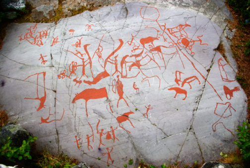 Ancient red carving on a rock in Alta, Norway