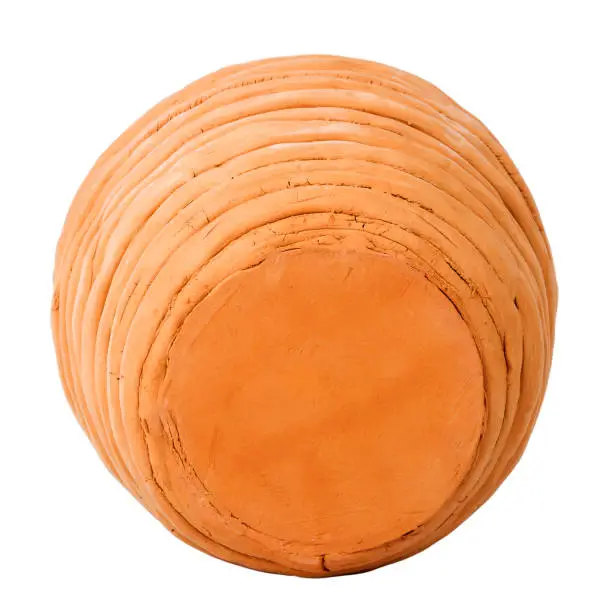 Unglazed handmade coiled pottery pot made of red clay isolated on white background. Teracota vase. Pottery basics.