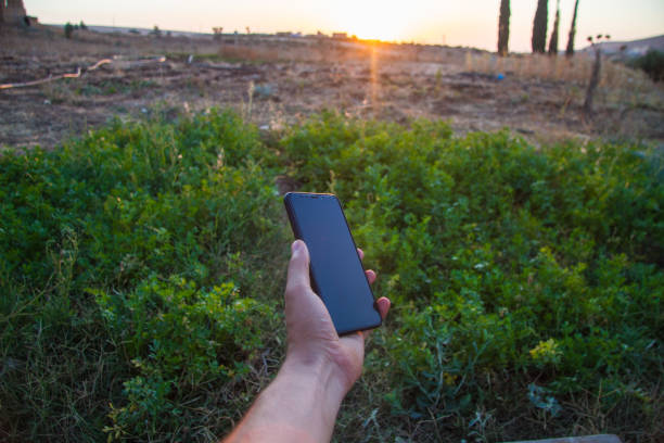 istock farmer with mobile phone in hands in the field 1039909806