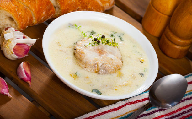 Creamy soup with merluza Appetizing thick creamy soup with tender fillet of merluza served in soup plate merluza stock pictures, royalty-free photos & images