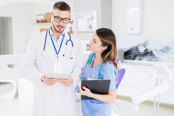 istock Serious medical colleagues in uniform discussing diagnose and treatment while viewing online medical card in clinic 1039923192