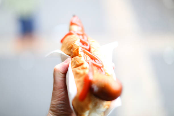 London, UK - April 8, 2016: A hot dog with ketchup shot with a narrow depth of focus in Borough Market in London