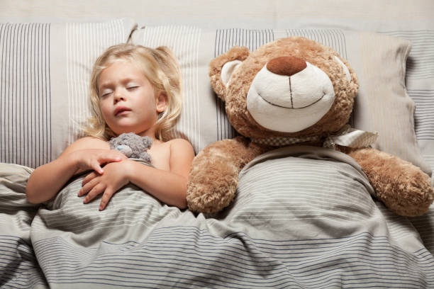 istock Kid girl and teddy bear in bed, nightmare problem. Scared, stress 1039929752