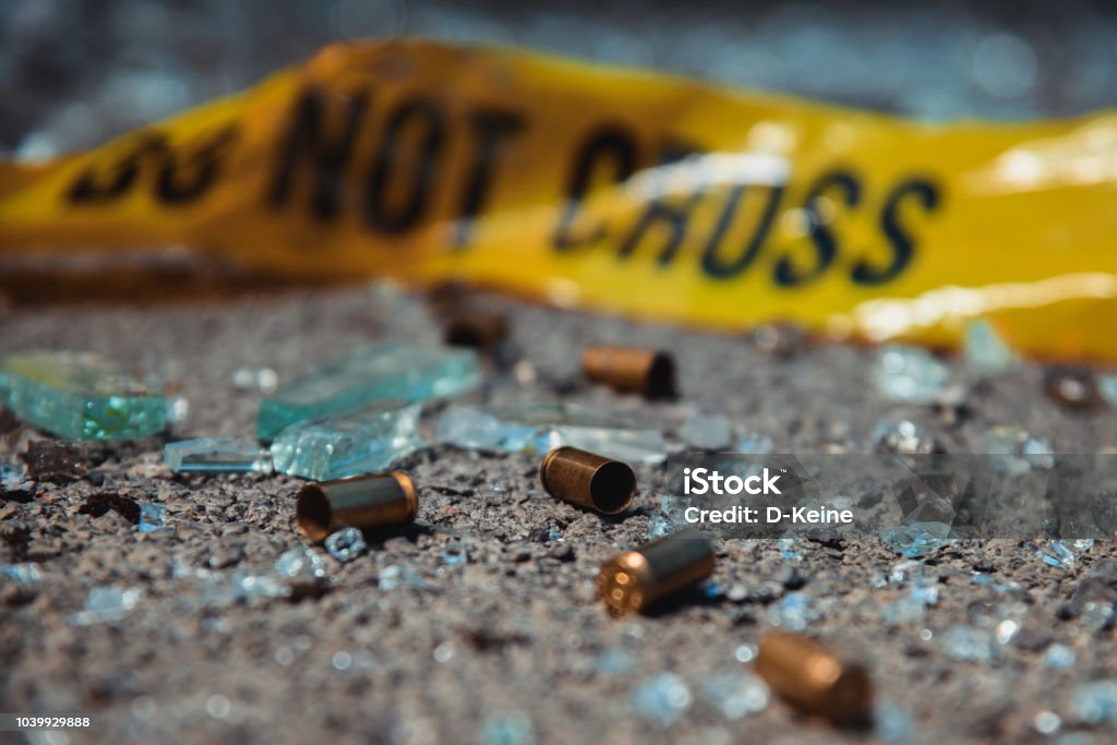 Bullet casings Bullet casings and broken glass. Crime scene. Gun Stock Photo