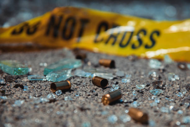 Bullet casings Bullet casings and broken glass. Crime scene. bullet cartridge photos stock pictures, royalty-free photos & images