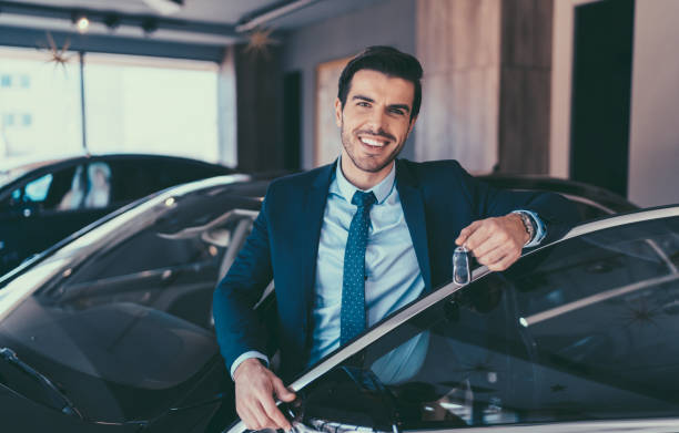 Businessman enjoying new car Man holding the car keys of his new car salesman stock pictures, royalty-free photos & images