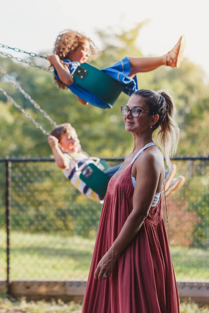 istock Neighbors talking and children playing in the park 1039932162