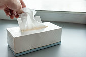 Hand picking white tissue paper