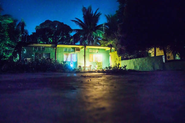 Bacalar, Mexico - September 13 2018: Backyard at night with green house and lightened rooms and terrace