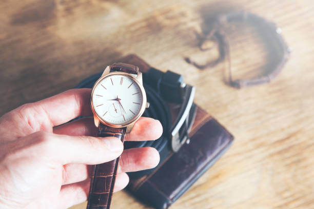 istock Man hand watch and accessorise on table 1039946142